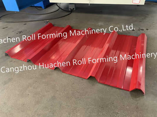 A metal roof panel manufacturing machine for producing tile-shaped corrugated roof panels by rolling process